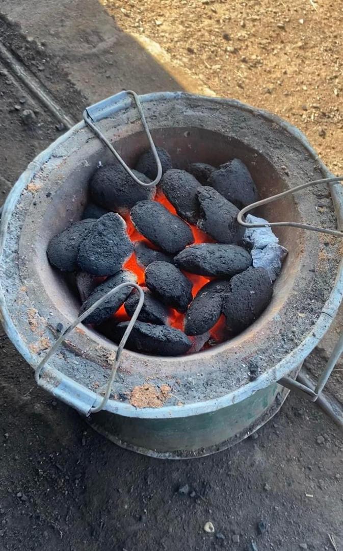 Briquettes glowing in a mbaula